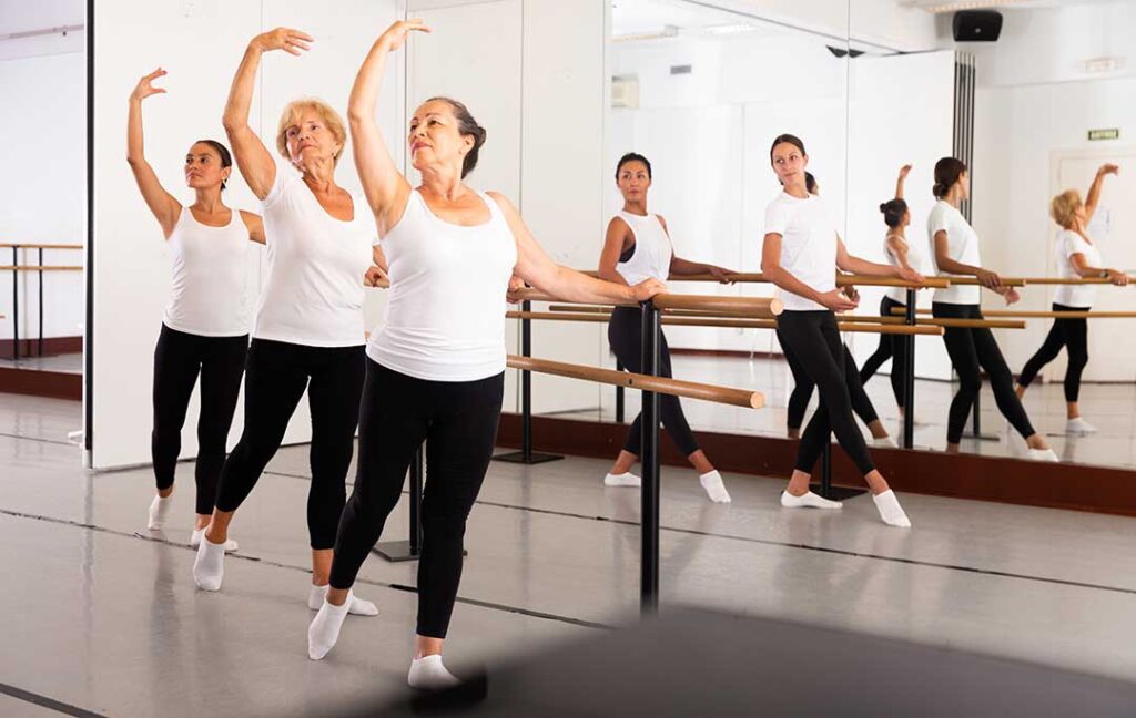 Young dancer sits beside a studio mirror while reviewing notes after an audition.